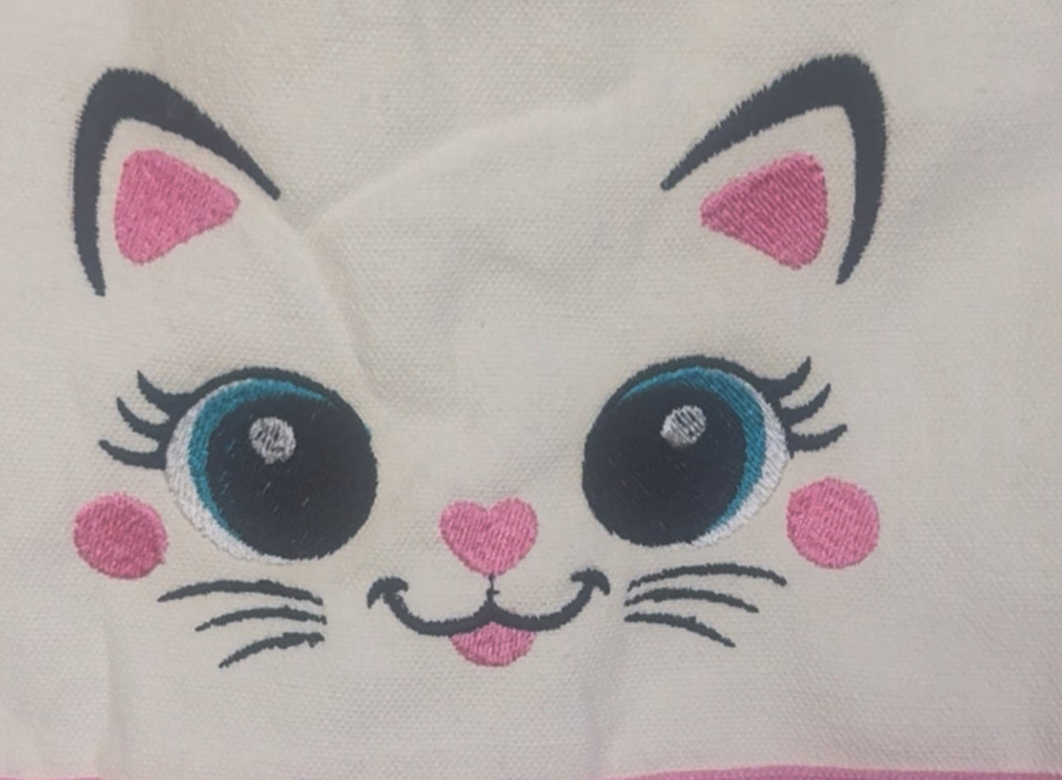 Embroidered cat face design on a white background